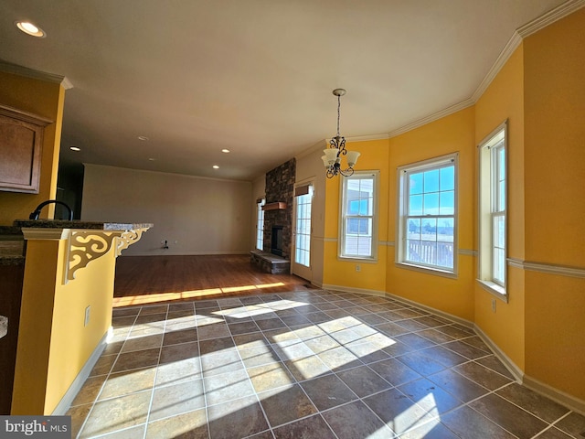 interior space with a fireplace, dark wood-type flooring, crown molding, and a chandelier