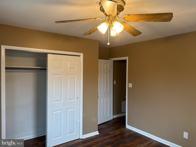 unfurnished bedroom with a closet, ceiling fan, and dark wood-type flooring