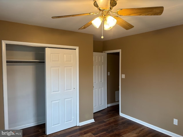 unfurnished bedroom featuring dark hardwood / wood-style flooring, a closet, and ceiling fan