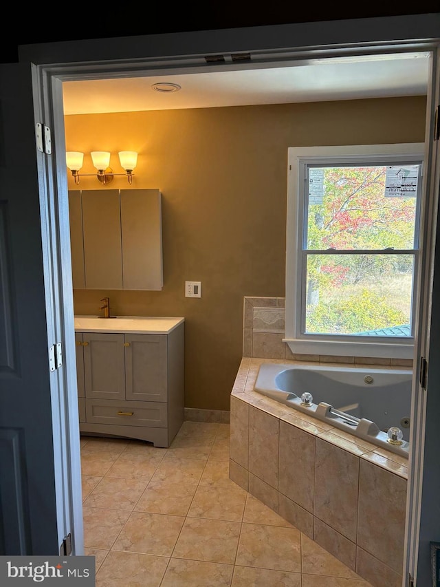 bathroom featuring vanity, tiled bath, and tile patterned floors