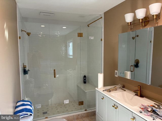 bathroom with vanity, tile patterned floors, and walk in shower