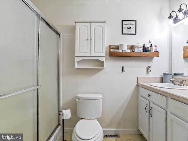 bathroom with walk in shower, vanity, toilet, and tile patterned floors