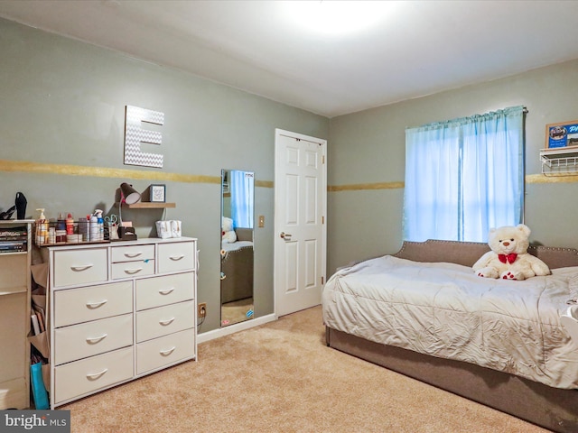 bedroom featuring light carpet