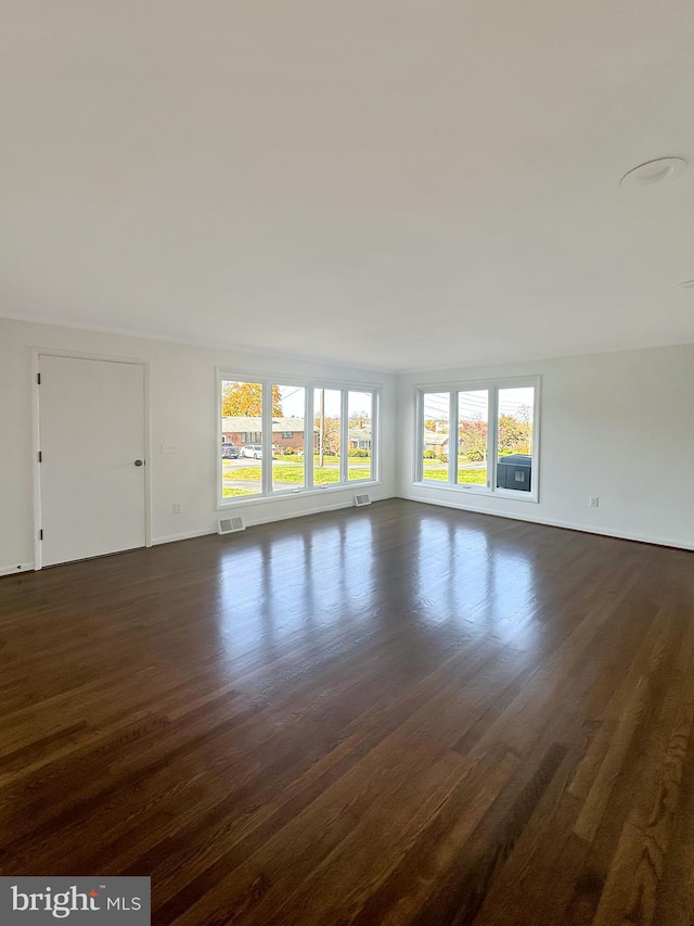 unfurnished room with dark hardwood / wood-style floors