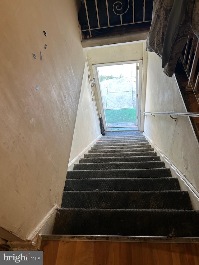 stairs featuring hardwood / wood-style flooring