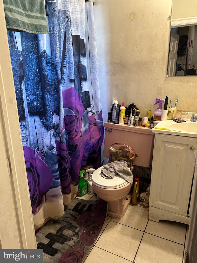 bathroom featuring a shower with curtain, vanity, tile patterned flooring, and toilet