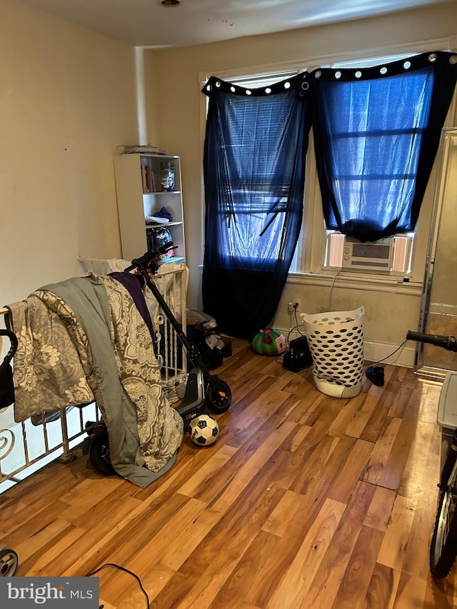 interior space featuring cooling unit and hardwood / wood-style flooring