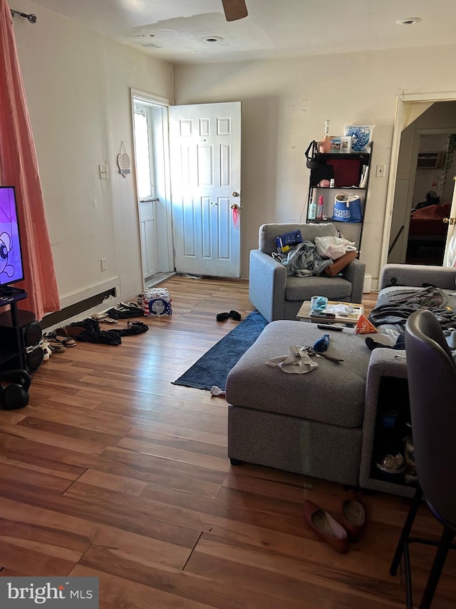 living room with ceiling fan and hardwood / wood-style floors