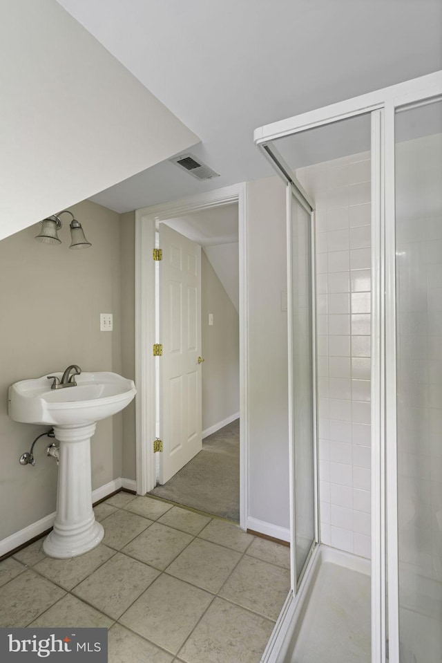 full bath with tile patterned flooring, visible vents, a shower stall, and baseboards