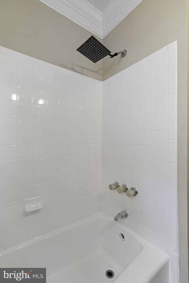 bathroom featuring ornamental molding and shower / tub combination