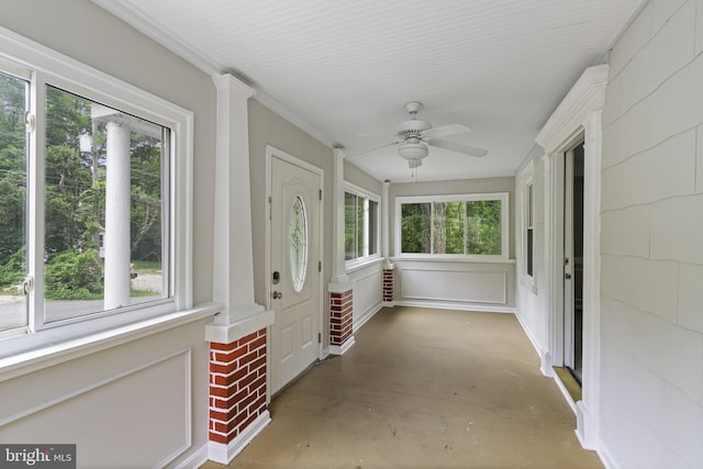 unfurnished sunroom with a ceiling fan