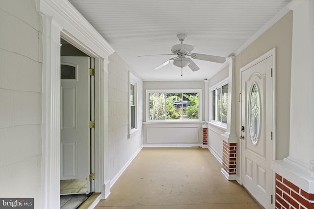 unfurnished sunroom with a ceiling fan