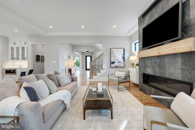 living room featuring light wood-type flooring, plenty of natural light, and a fireplace