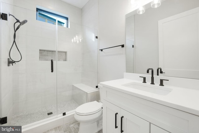 bathroom featuring vanity, toilet, and an enclosed shower