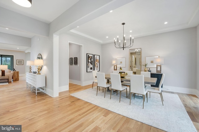 dining room featuring light hardwood / wood-style floors and a chandelier