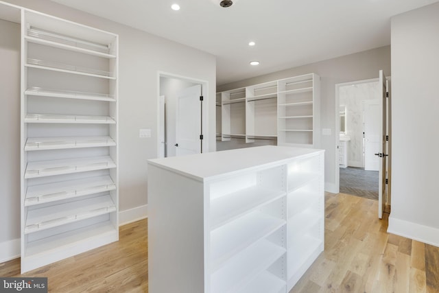 walk in closet with light wood-type flooring