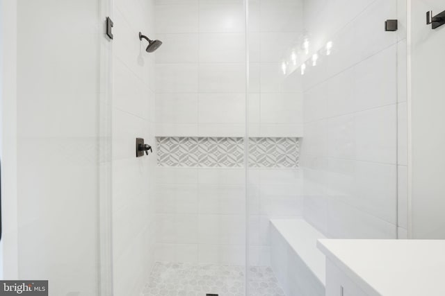 bathroom with vanity and a shower with door