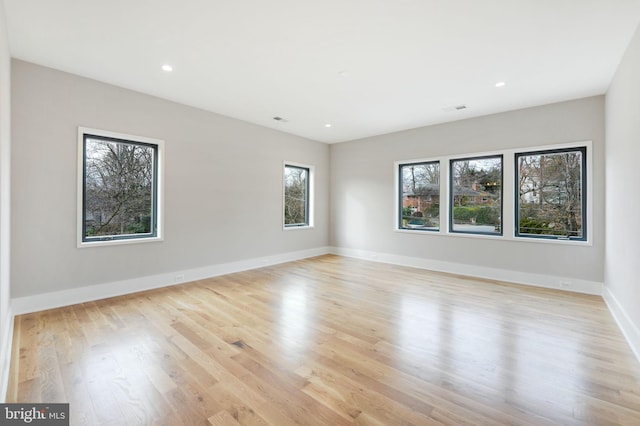 unfurnished room with light wood-type flooring