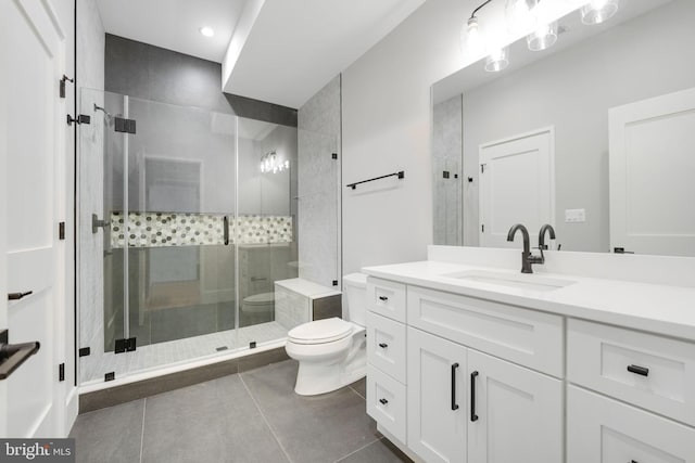 bathroom with tile patterned floors, an enclosed shower, vanity, and toilet