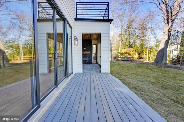 wooden deck with a lawn