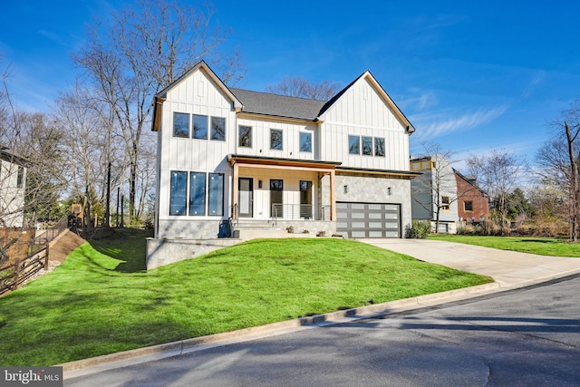 modern farmhouse with covered porch, a front yard, and a garage