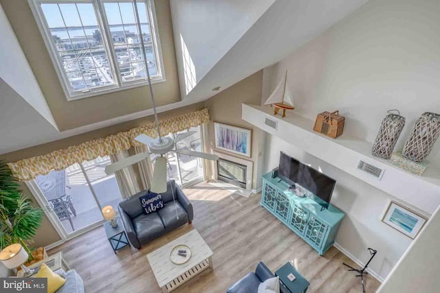 living room with a towering ceiling and hardwood / wood-style floors