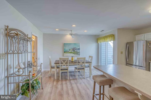 dining room with ceiling fan and light wood-type flooring