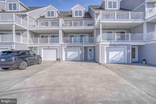 view of property with a balcony and a garage