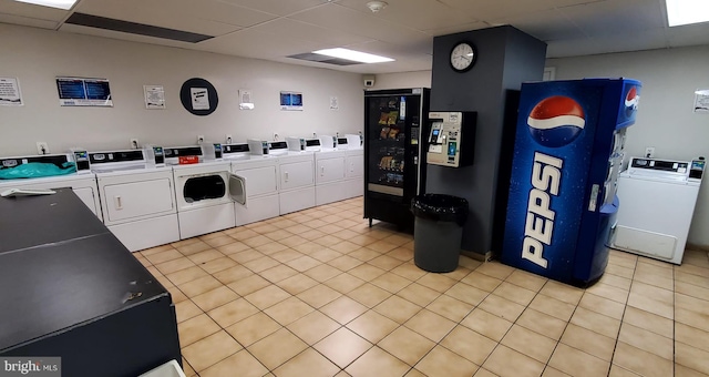 washroom with light tile patterned floors and washing machine and clothes dryer