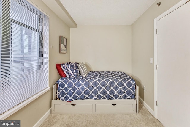 bedroom featuring light carpet