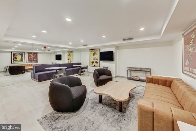 living room with a tray ceiling