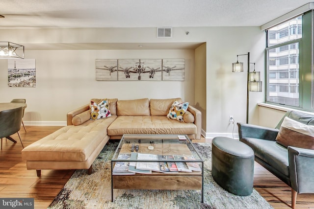 living room featuring a textured ceiling and hardwood / wood-style floors