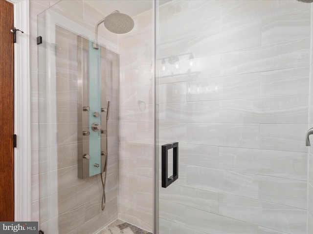 bathroom with a shower with door