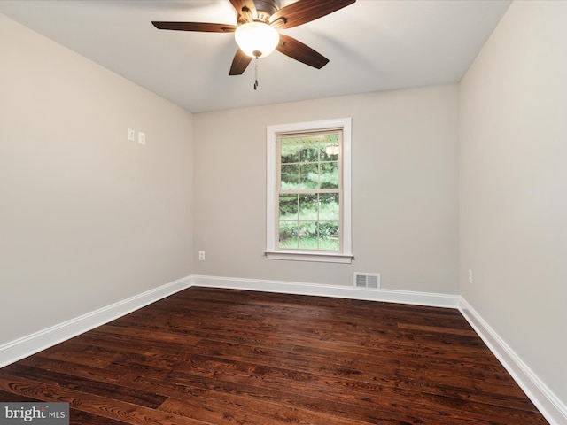 empty room with dark hardwood / wood-style floors and ceiling fan