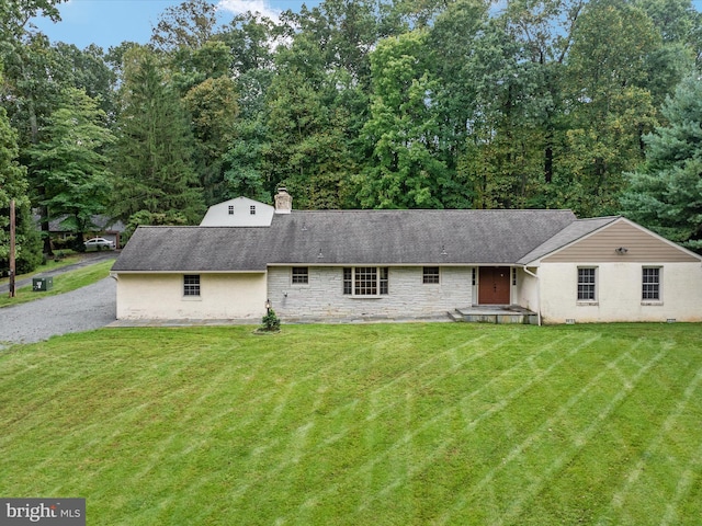 view of front of house with a front lawn and a patio