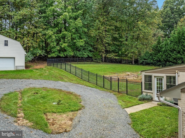 view of yard featuring a garage and an outdoor structure