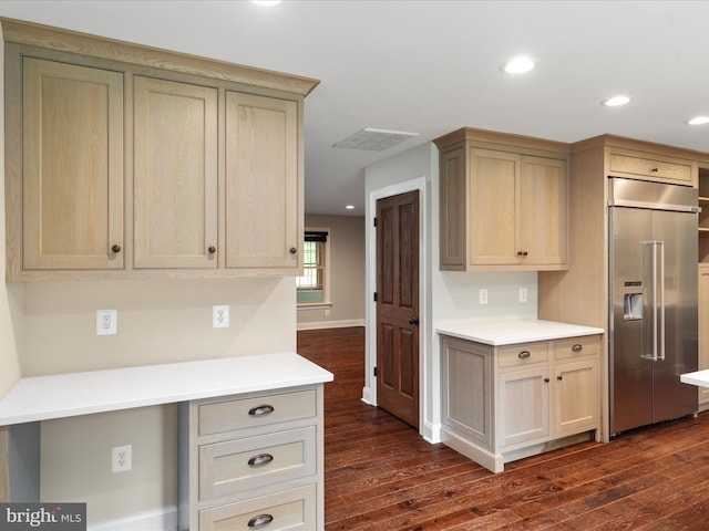 kitchen featuring light brown cabinetry, built in refrigerator, and dark hardwood / wood-style flooring