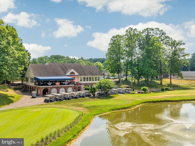 view of property's community featuring a water view and a lawn