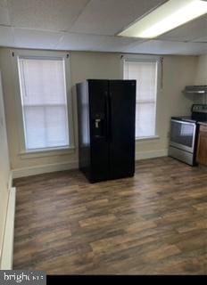 kitchen with black fridge, dark wood-type flooring, ventilation hood, electric stove, and a baseboard radiator