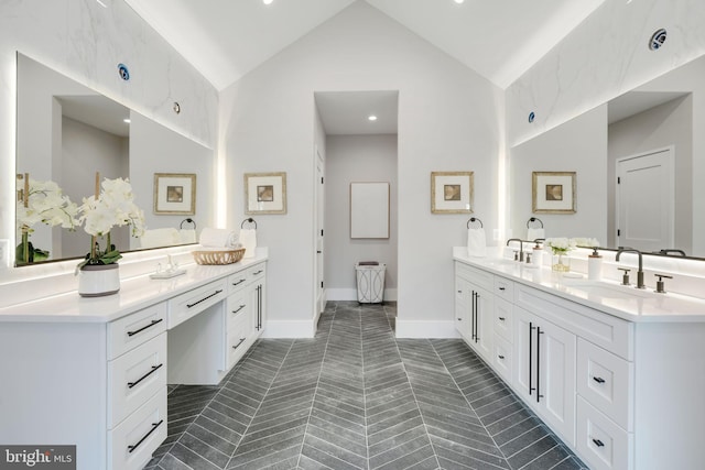 bathroom with tile patterned flooring, vanity, and vaulted ceiling