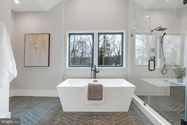 bathroom featuring shower with separate bathtub