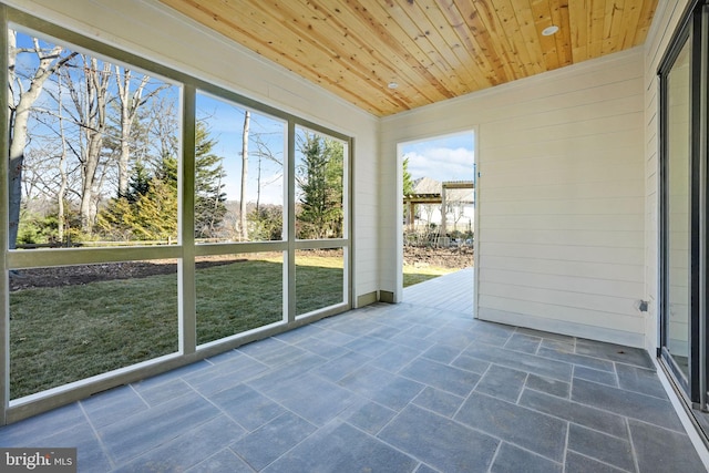 unfurnished sunroom featuring wood ceiling