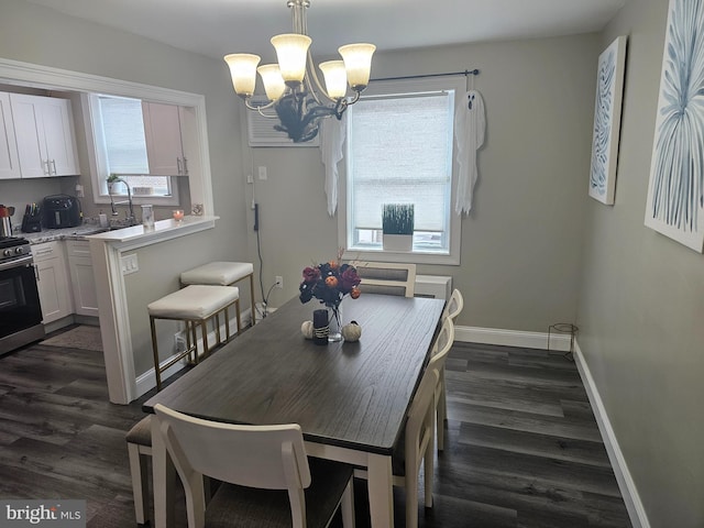 dining room with an inviting chandelier, dark wood-type flooring, and sink