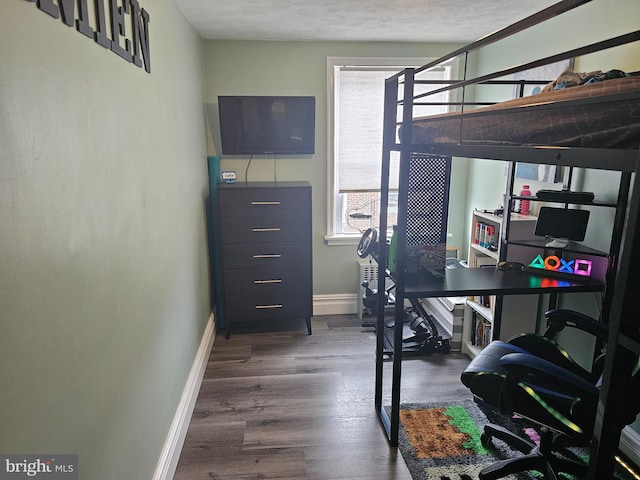 workout area with a textured ceiling and dark hardwood / wood-style flooring