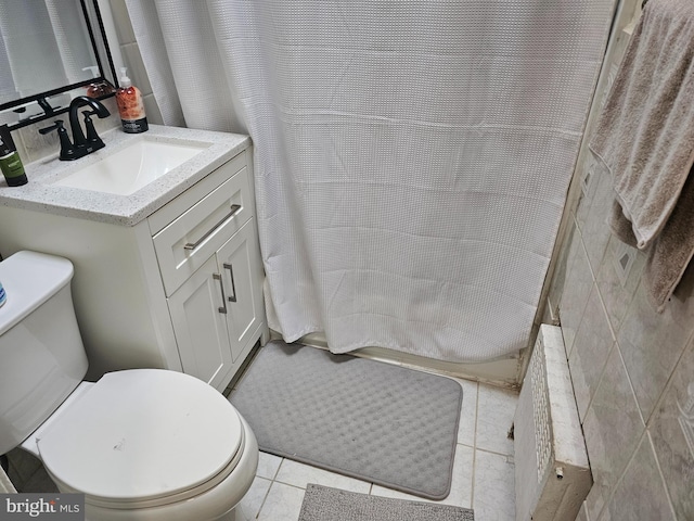 bathroom featuring tile walls, tile patterned flooring, a shower with shower curtain, vanity, and toilet