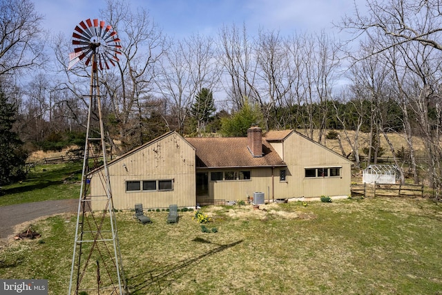 rear view of house with a lawn