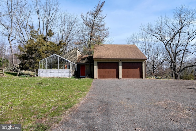 exterior space with a garage and a yard