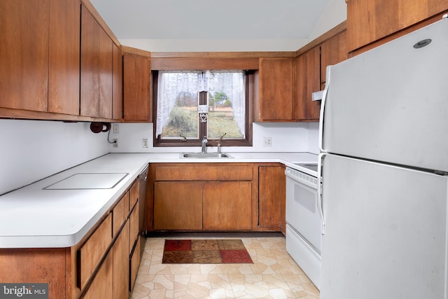 kitchen featuring white appliances, sink, and light tile patterned floors