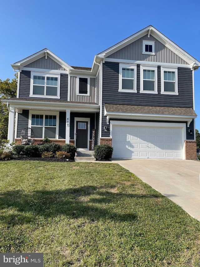 view of front of house with a garage and a front lawn