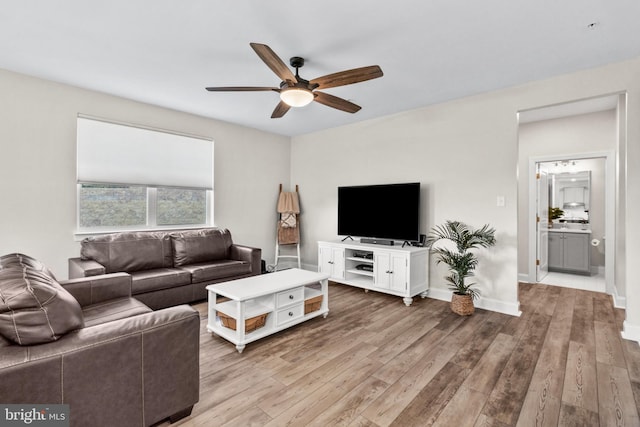 living room featuring ceiling fan and hardwood / wood-style floors